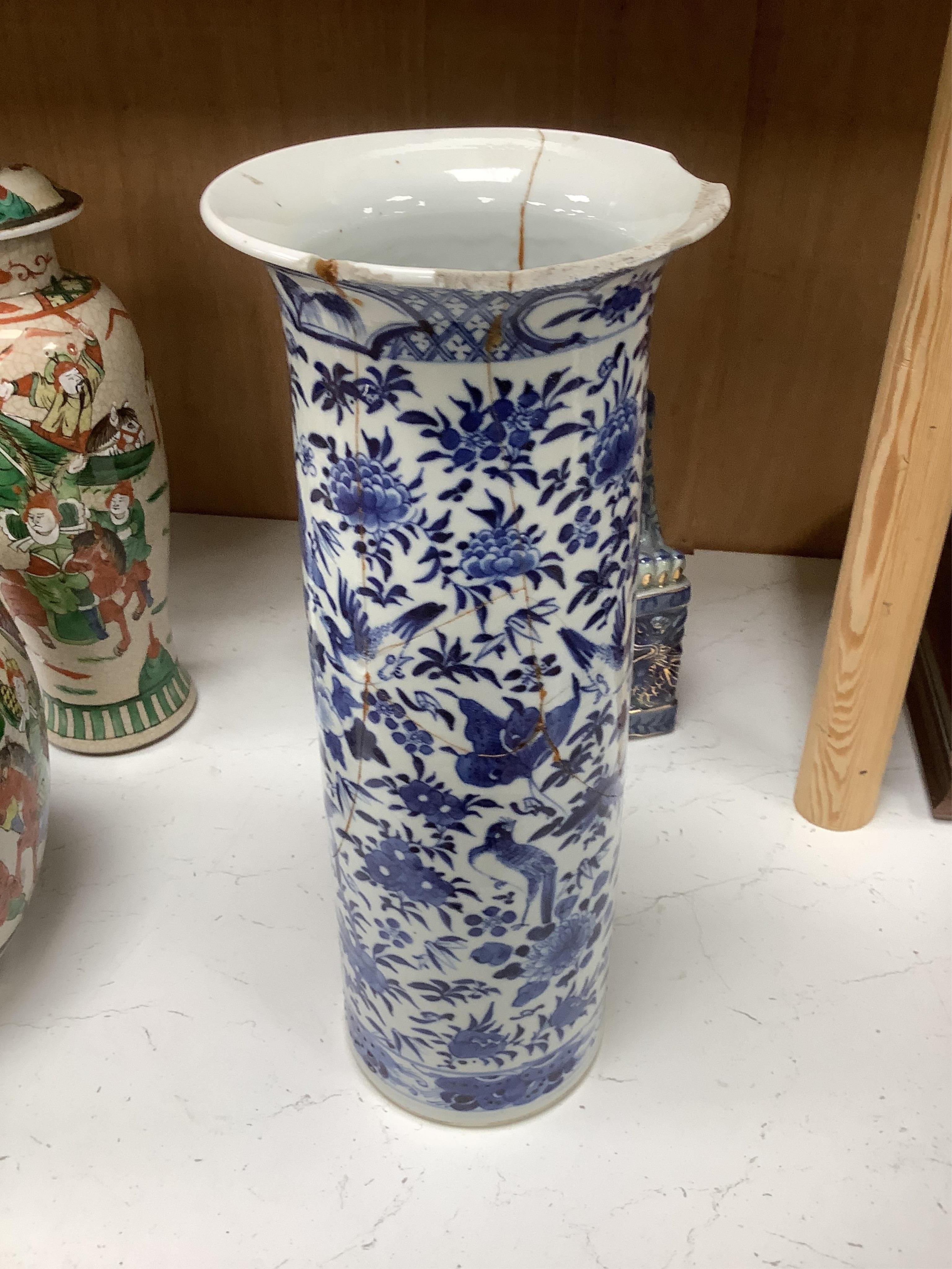 A group of Chinese ceramics including a large blue and white sleeve vase, circa 1900, two crackle glazed vases and covers, similar jar, a prunus jar and a pair of lion dogs, largest 36cm (7). Condition - poor to fair
